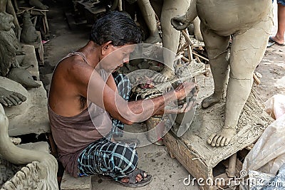 The potters of Kolkata are preparing idols of Goddess Devi Durga and paint those for Durga Puja festival, biggest religious Editorial Stock Photo