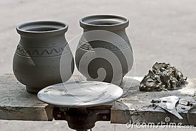 Fresh made pottery and potter wheel Stock Photo