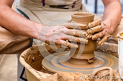 Pottery artist making clay pot in a workshop Stock Photo