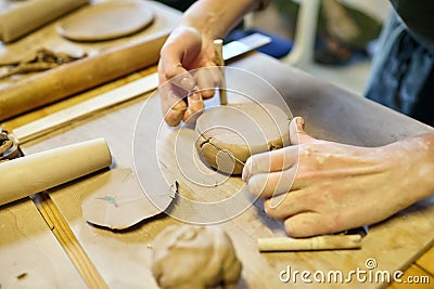 Pottery. A girl with a string in her hands and clod clay Stock Photo