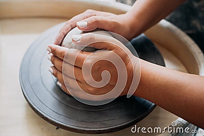 Pottery wheel, clay, woman`s hands, potter is going to work in pottery Stock Photo