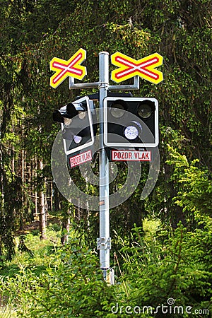 Potucky, Czech Republic - June 11, 2023: Railroad crossing in a forest with warning light and Pozor vlak sign, or Beware of train Editorial Stock Photo