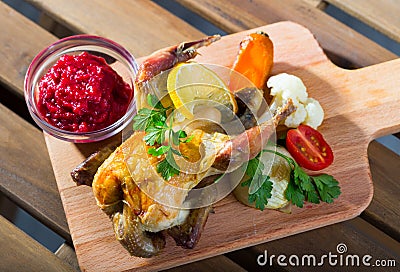 Roasted partridge with cranberry sauce Stock Photo