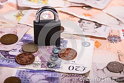 Pound money and padlock Editorial Stock Photo