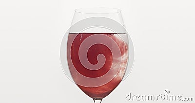 Pour blueberry juice into water in wine glass Stock Photo