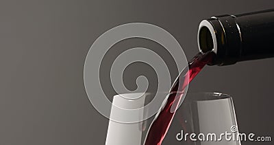 pour red wine into wineglass over black baground Stock Photo