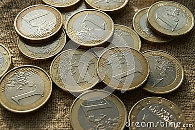 Poured 1 Euro coins on natural linen fabric. European money. Stock Photo