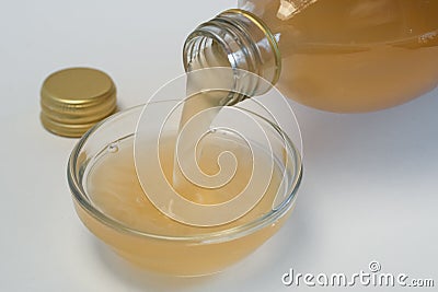 Pouring Apple Cider Vinegar into an Ingredient Bowl Stock Photo