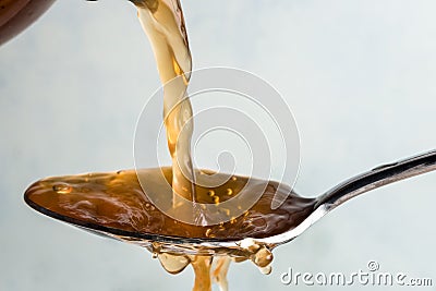 Pouring Apple Cider Vinegar onto a Spoon Stock Photo