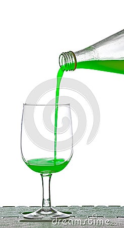 Pouring apple juice from bottle into glass Stock Photo