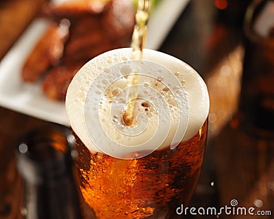 Pouring beer into glass Stock Photo