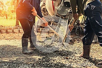 pouring concrete with worker mix cement at construction Stock Photo