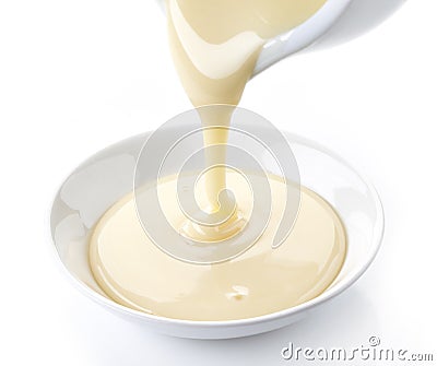 Pouring condensed milk Stock Photo