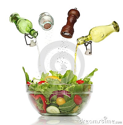 Pouring condiments on a colorful salad. Stock Photo