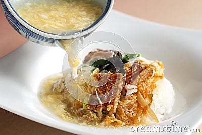 Pouring crab soup with braised eel rice Stock Photo