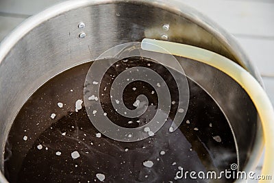 Pouring Craft Home Brew Beer Wort into the Boil Kettle Stock Photo