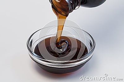 Pouring Dark Corn Syrup from a Bottle Stock Photo