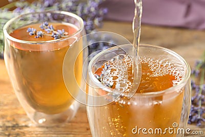 Pouring delicious lavender tea into glass Stock Photo