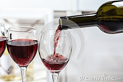 Pouring delicious red wine into glass Stock Photo