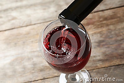 Pouring delicious red wine into glass Stock Photo