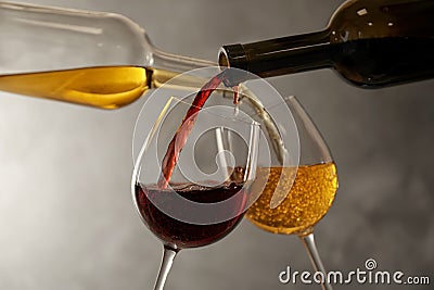 Pouring different wines from bottles into glasses Stock Photo