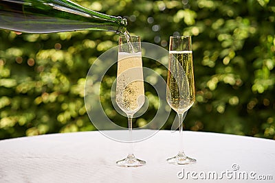 Pouring a glass of white sparkling wine or champagne Stock Photo