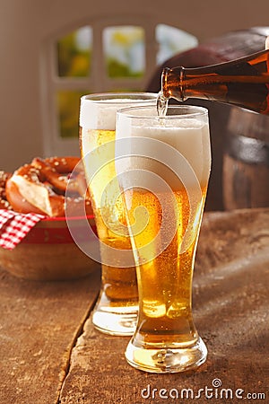 Pouring glasses of frothy beer Stock Photo