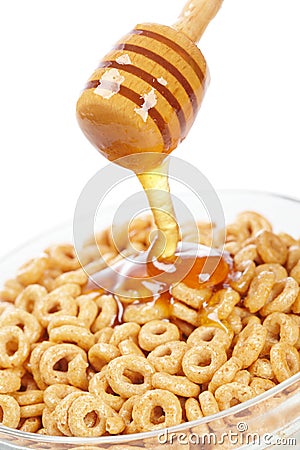 Pouring honey on cornflakes Stock Photo