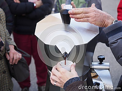 Pouring hot coffee in the street. Stock Photo