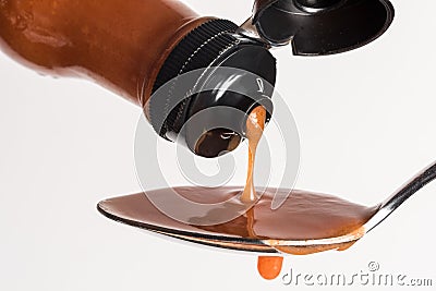 Pouring Hot Sauce on a Spoon Stock Photo