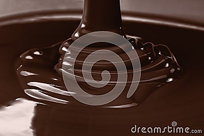 Pouring liquid hot chocolate closeup. Cooking dessert. Stock Photo