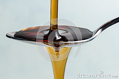 Pouring Maple Syrup on a Spoon Stock Photo