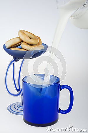 Pouring milk and bagels. Stock Photo