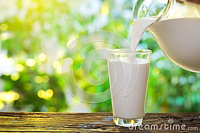 Pouring milk in the glass. Stock Photo