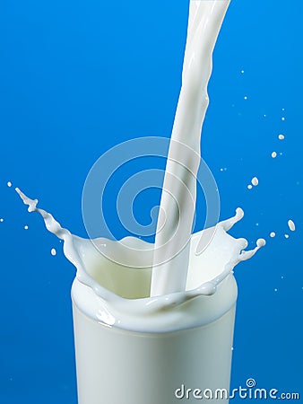 Pouring milk in a glass isolated Stock Photo