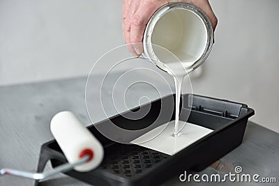 Pouring paint into a painting tray Stock Photo