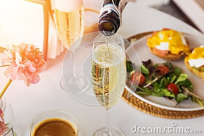 Pouring prosecco sparkling wine in a glass on sunday brunch Stock Photo