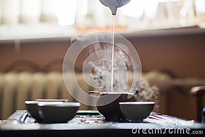 Pouring of Puer Tea from Teapot at Traditional Chinese Tea Ceremony. Set of Equipment for Drinking Tea Stock Photo