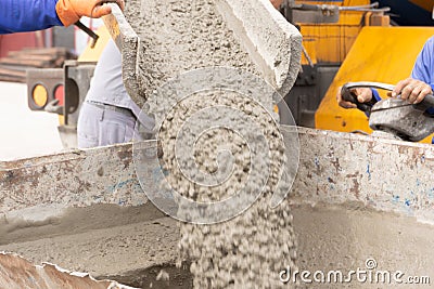 Pouring ready-mixed concrete from mixing mobile the concrete mixer Stock Photo