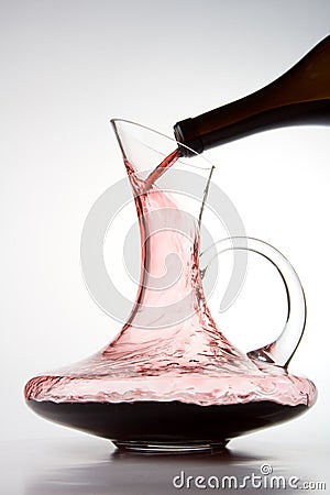 Pouring red wine into decanter Stock Photo