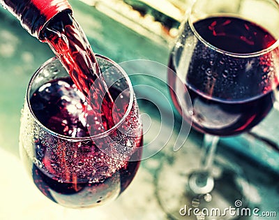 pouring red wine. Wine in a glass, selective focus, motion blur, Stock Photo