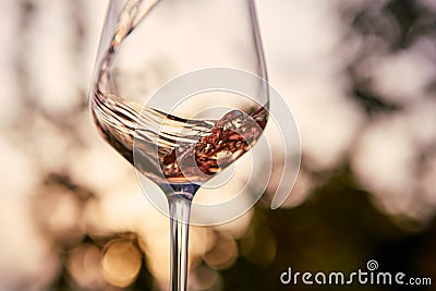 Pouring rose wine into a glass Stock Photo