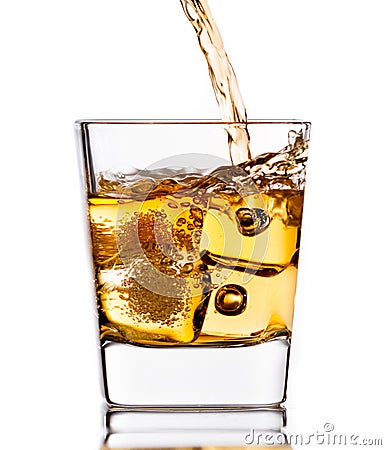 Pouring scotch whiskey in glass with ice cubes on white Stock Photo
