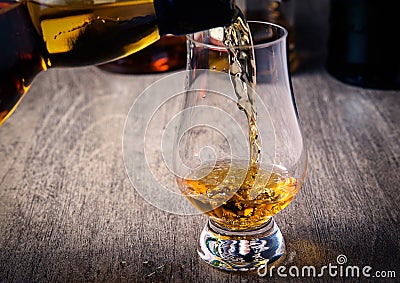 Pouring single malt scotch whisky into whisky glass Stock Photo