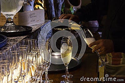 Pouring sparkling wine into a glass in a restaurant. Editorial Stock Photo