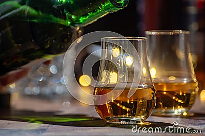 Pouring in Speyside whisky glass of whisky, single malt and blended scotch whisky served in bar in Edinburgh, Scotland, UK with Stock Photo