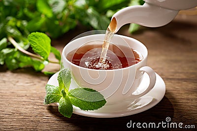 Pouring tea into a cup Stock Photo