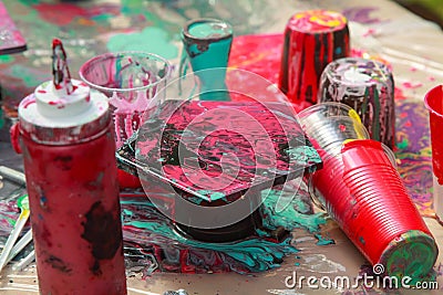 Pouring thick acrylic paint on ceramic tiles. Art training Stock Photo