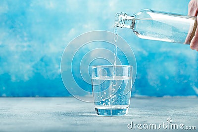 Pouring water from bottle into glass Stock Photo