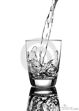 Pouring water on a glass Stock Photo